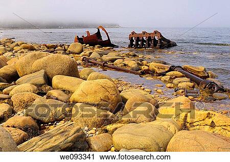Stock Image - Rusted remains of the SS Ethie coastal steamship that ran aground in a 1919 storm at Martin Point. Fotosearch