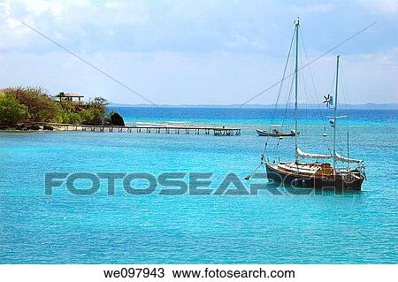 Sailboat anchored in gorgeous blue caribbean water View Large Photo Image Stock Image - Sailboat anchored in gorgeous blue caribbean water. Fotosearch
