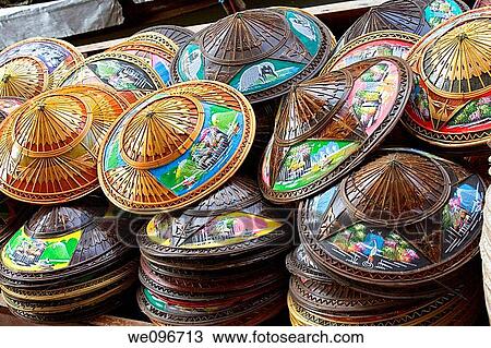Stock Image - Selling souvenirs at the Damnoen Saduak floating market located about 62 miles outside of Bangkok Thailand. Fotosearch