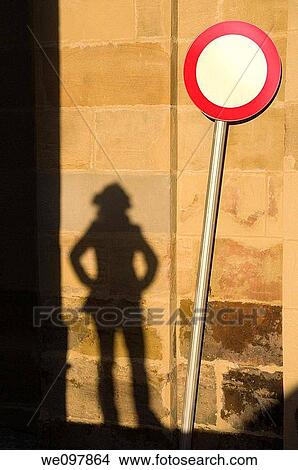 Shadow of woman looking at traffic sign View Large Photo Image Picture - Shadow of woman looking at traffic sign. Fotosearch