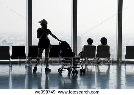 Silhouette of a woman with a baby carriage and two women sitting in chairs and looking out a picture window Tokyo City View in Roppongi Hills, Tokyo, Japan View Large Photo Image Stock Photo - Silhouette of a woman with a baby carriage and two women sitting in chairs and looking out a picture window Tokyo City View in Roppongi Hills, Tokyo, Japan. Fotosearch