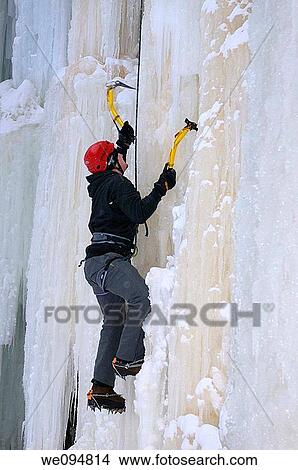 Single ice climber front pointing up sheer vertical wall of ice on belay at Tiffany Falls Ontario View Large Photo Image Picture - Single ice climber front pointing up sheer vertical wall of ice on belay at Tiffany Falls Ontario. Fotosearch