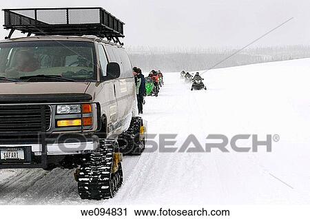 Snowmobiler and snowcoach group stopped for pictures on Norris Canyon Road in Yellowstone National Park in winter View Large Photo Image Stock Image - Snowmobiler and snowcoach group stopped for pictures on Norris Canyon Road in Yellowstone National Park in winter. Fotosearch