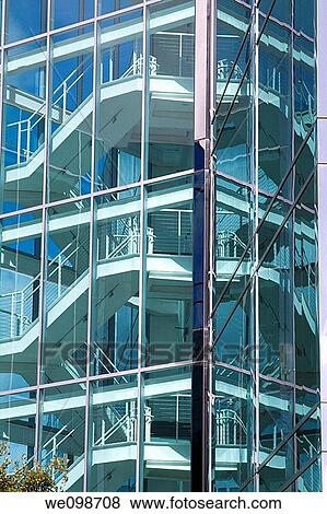 Staircase of sleek, modern office building in Silicon Valley as seen through glass walls. San Mateo, California, USA View Large Photo Image Stock Photo - Staircase of sleek, modern office building in Silicon Valley as seen through glass walls. San Mateo, California, USA. Fotosearch