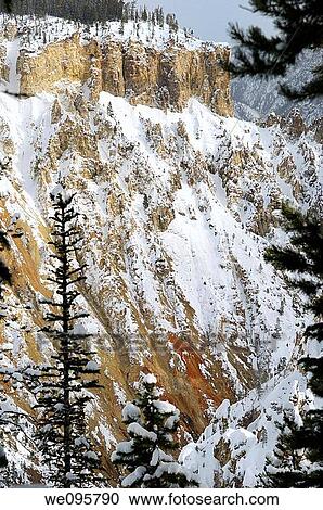 Stock Image - Steep eroded rust red rocks in Grand Canyon of the Yellowstone in winter. Fotosearch