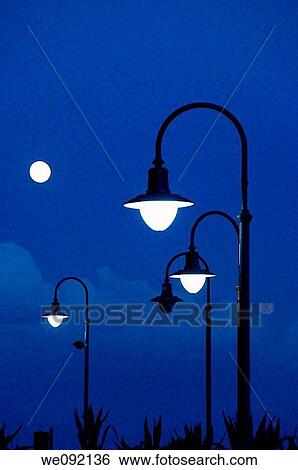 Stock Photograph - Street lamps at dusk. Fotosearch
