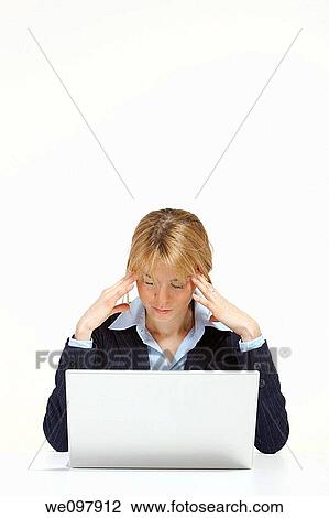 Stressed blonde business woman working in office with laptop View Large Photo Image Stock Image - Stressed blonde business woman working in office with laptop. Fotosearch