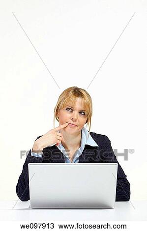 Stressed blonde business woman working in office with laptop View Large Photo Image Stock Image - Stressed blonde business woman working in office with laptop. Fotosearch