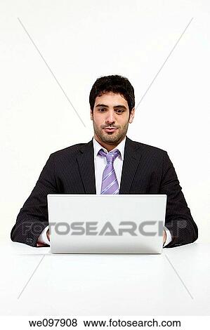 Stressed business man working in office with laptop View Large Photo Image Stock Photo - Stressed business man working in office with laptop. Fotosearch