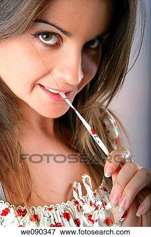 Stock Photo - Studio portrait of girl lewd gesture.. Fotosearch