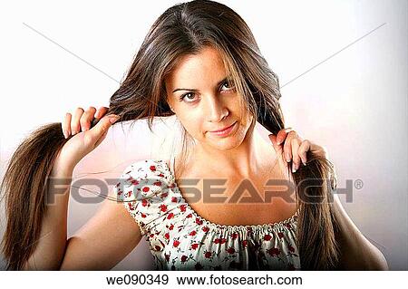 Studio Shot of girl clutching the long hair. View Large Photo Image Stock Photo - Studio Shot of girl clutching the long hair.. Fotosearch