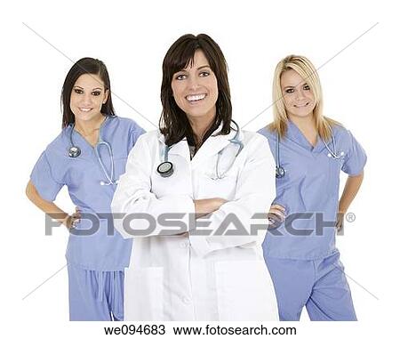 Stock Image - Successful young doctors smiling over a white background. Fotosearch
