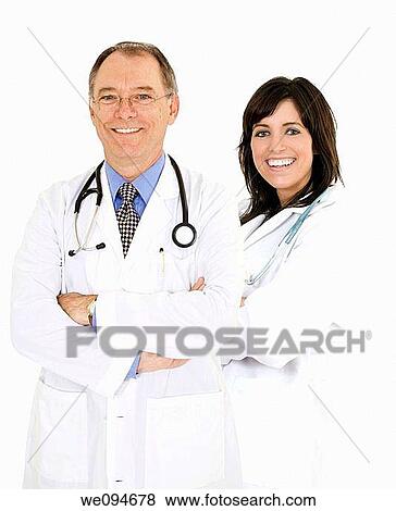 Successful young doctors smiling over a white background View Large Photo Image Stock Photo - Successful young doctors smiling over a white background. Fotosearch