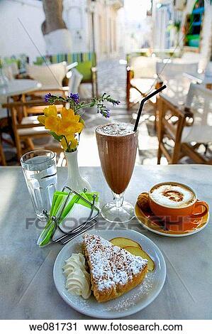 Sugar cake, milk shake and coffee in an outdoor caf?, Parikia, Paros, Cyclades islands, Greece View Large Photo Image Stock Image - Sugar cake, milk shake and coffee in an outdoor caf?, Parikia, Paros, Cyclades islands, Greece. Fotosearch