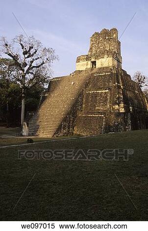 Stock Photography - Sunrise over Mayan ruins of Temple I, Temple of the Grand Jaguar, in the Great Plaza of UNESCO World Heritage site of Tikal- Tikal National Park, Guatemala. Fotosearch