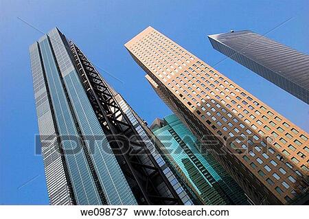 Tall modern office buildings towering into the sky in the Shiodome district of Tokyo, Japan View Large Photo Image Stock Photo - Tall modern office buildings towering into the sky in the Shiodome district of Tokyo, Japan. Fotosearch