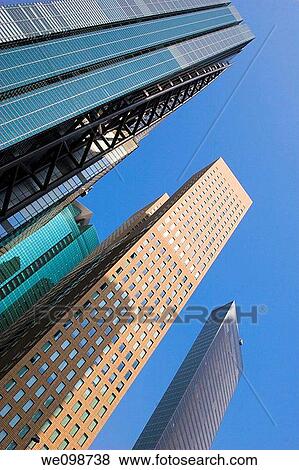 Tall modern office buildings towering into the sky in the Shiodome district of Tokyo, Japan View Large Photo Image Stock Photo - Tall modern office buildings towering into the sky in the Shiodome district of Tokyo, Japan. Fotosearch