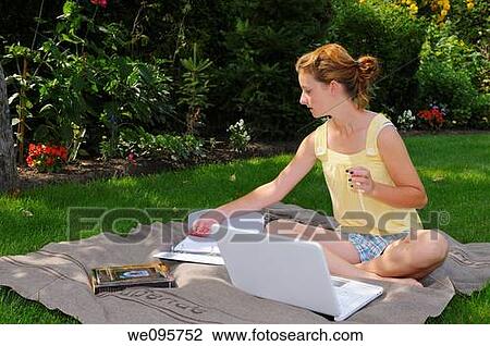 Teenager doing homework with laptop on a blanket in the back yard in the shade View Large Photo Image Stock Image - Teenager doing homework with laptop on a blanket in the back yard in the shade. Fotosearch
