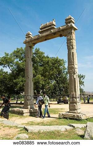 The King's Balance near Vijayavitthala Temple in Hampi, Karnataka. It consists of two lofty carved granite pillars about 15 feet high supporting a stone beam about 12 feet, provided with three hoops on the underside. One of the pillars has a bas-relief dep View Large Photo Image Stock Photography - The King's Balance near Vijayavitthala Temple in Hampi, Karnataka. It consists of two lofty carved granite pillars about 15 feet high supporting a stone beam about 12 feet, provided with three hoops on the underside. One of the pillars has a bas-relief dep. Fotosearch
