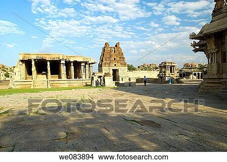 The Stone chariot and the Vijayavittala Temple tower in Hampi, karnataka. The construction of Vittala temple started during the reign of King Krishna Deva Raya in the year 1513 AD. The project was so colossal that the additions continued for almost five d View Large Photo Image Picture - The Stone chariot and the Vijayavittala Temple tower in Hampi, karnataka. The construction of Vittala temple started during the reign of King Krishna Deva Raya in the year 1513 AD. The project was so colossal that the additions continued for almost five d. Fotosearch