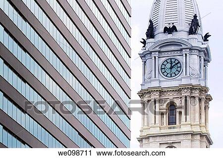 The traditional French architecture of the Philadelphia City Hall tower, with clock and statues, contasts with a modern office building with rows of windows Downtown Philadelphia, Pennsylvania View Large Photo Image Stock Image - The traditional French architecture of the Philadelphia City Hall tower, with clock and statues, contasts with a modern office building with rows of windows Downtown Philadelphia, Pennsylvania. Fotosearch