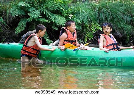 Three boys canoeing in the river, Eyre river, France View Large Photo Image Stock Photo - Three boys canoeing in the river, Eyre river, France. Fotosearch