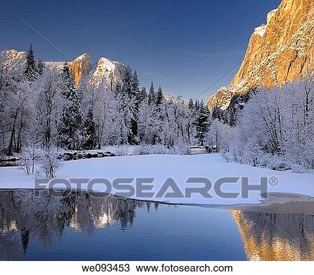Three Brothers face and Cathedral Spires reflected in the Merced River after a snowfall in Yosemite View Large Photo Image Stock Image - Three Brothers face and Cathedral Spires reflected in the Merced River after a snowfall in Yosemite. Fotosearch