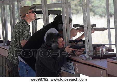 Three men shooting Ruger 10/22 rifles using scopes at the Los Altos Rod and Gun Club outdoor gun range View Large Photo Image Stock Image - Three men shooting Ruger 10/22 rifles using scopes at the Los Altos Rod and Gun Club outdoor gun range. Fotosearch