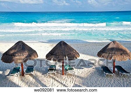 Three straw sun umbrellas on a white sandy beach View Large Photo Image Stock Image - Three straw sun umbrellas on a white sandy beach. Fotosearch