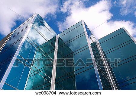 Three towers of a sleek modern glass office building in Silicon Valley with the clouds and sky reflecting in the surface. San Mateo, California, USA. View Large Photo Image Picture - Three towers of a sleek modern glass office building in Silicon Valley with the clouds and sky reflecting in the surface. San Mateo, California, USA.. Fotosearch