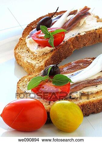Toast with cheese, anchovies, tomatoes, olives and onion View Large Photo Image Picture - Toast with cheese, anchovies, tomatoes, olives and onion. Fotosearch