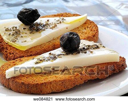 Toast with cheese, oil olive and black olives View Large Photo Image Stock Image - Toast with cheese, oil olive and black olives. Fotosearch