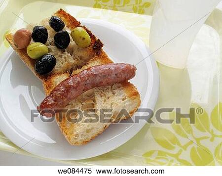 Stock Photography - Toast with oil, sausages and olives. Fotosearch