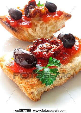 Toast with tomato confit, dried tomato and black olives View Large Photo Image Stock Photo - Toast with tomato confit, dried tomato and black olives. Fotosearch