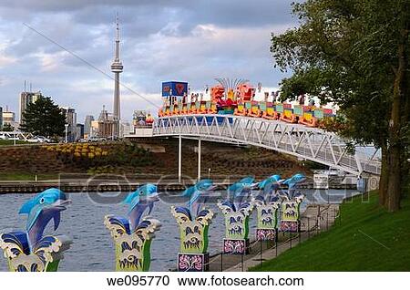 Stock Image - Toronto skyline at dusk with CN Tower and Chinese Lantern Festival displays from Ontario Place. Fotosearch