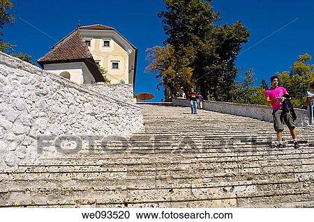Tourists decending the steps that lead to St. Mary's Church, Lake Bled, Slovenia View Large Photo Image Stock Image - Tourists decending the steps that lead to St. Mary's Church, Lake Bled, Slovenia. Fotosearch