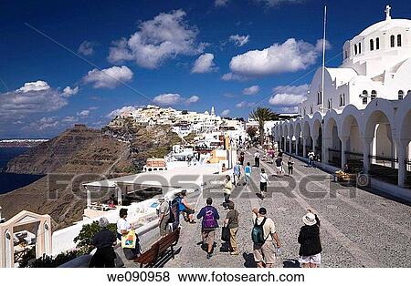 Tourists on the promenade at Fira village, Santorini, Greece View Large Photo Image Stock Photo - Tourists on the promenade at Fira village, Santorini, Greece. Fotosearch