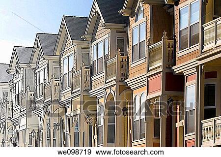 Townhouses in the Victorian architecture style with bay windows, balconies, and arched entrances The image starts out as a line drawing and transitions to a photo of the row houses, suggesting the idea of building plans turning into reality View Large Photo Image Stock Photo - Townhouses in the Victorian architecture style with bay windows, balconies, and arched entrances The image starts out as a line drawing and transitions to a photo of the row houses, suggesting the idea of building plans turning into reality. Fotosearch
