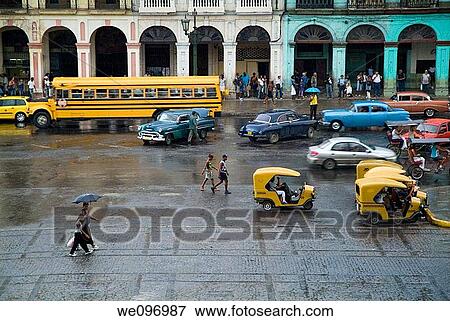 Traffic by a rainy day nearby the Capitol in Havana streets, Cuba View Large Photo Image Stock Photo - Traffic by a rainy day nearby the Capitol in Havana streets, Cuba. Fotosearch