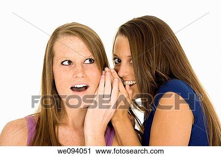 Two beautiful caucasian women telling secret on a white background View Large Photo Image Stock Image - Two beautiful caucasian women telling secret on a white background. Fotosearch