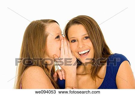 Two beautiful caucasian women telling secret on a white background View Large Photo Image Stock Image - Two beautiful caucasian women telling secret on a white background. Fotosearch