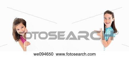 Two Cute Caucasian girls holding a blank sign View Large Photo Image Stock Image - Two Cute Caucasian girls holding a blank sign. Fotosearch
