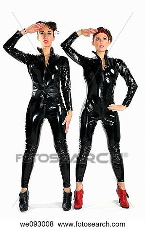 Two saluting young women models in black plastic catsuits on white background View Large Photo Image Stock Photo - Two saluting young women models in black plastic catsuits on white background. Fotosearch