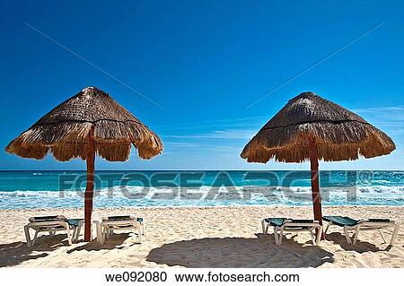 Two straw sun umbrella by a white sandy beach View Large Photo Image Stock Image - Two straw sun umbrella by a white sandy beach. Fotosearch