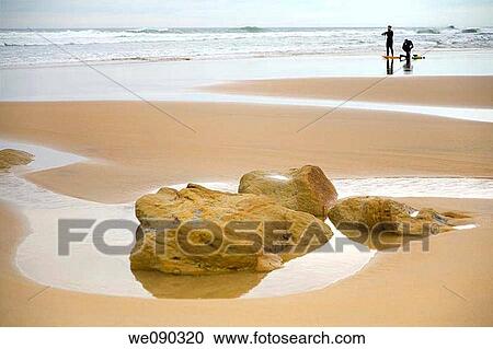 two surfers on a beach. Liencres beach. Cantabria, Spain, Europe View Large Photo Image Stock Image - two surfers on a beach. Liencres beach. Cantabria, Spain, Europe. Fotosearch