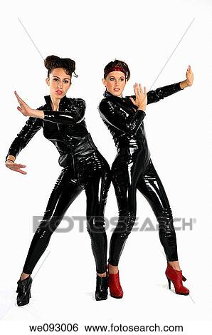 Two young women in secret agent karate mode in black plastic catsuits on white background View Large Photo Image Stock Photograph - Two young women in secret agent karate mode in black plastic catsuits on white background. Fotosearch