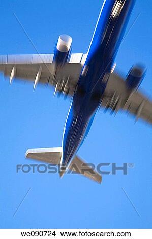 Underside view of a commercial jet airplane in flight with motion effect, Dorval, Quebec, Canada View Large Photo Image Picture - Underside view of a commercial jet airplane in flight with motion effect, Dorval, Quebec, Canada. Fotosearch
