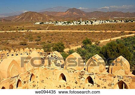 Stock Photography - View across the tower battlements of Jabrin castle to Jabrin village by the Hajar al Gharbi Mountains, Dhakiliya Region, Sultanate of Oman. Fotosearch