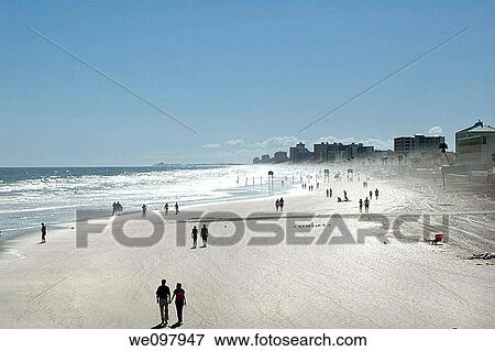View of people walking on beach, Daytona Florida View Large Photo Image Stock Photo - View of people walking on beach, Daytona Florida. Fotosearch