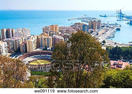 View of the bullring and port of Malaga from the Alcazaba. Malaga. Andalucia. Spain. View Large Photo Image Stock Photo - View of the bullring and port of Malaga from the Alcazaba. Malaga. Andalucia. Spain.. Fotosearch